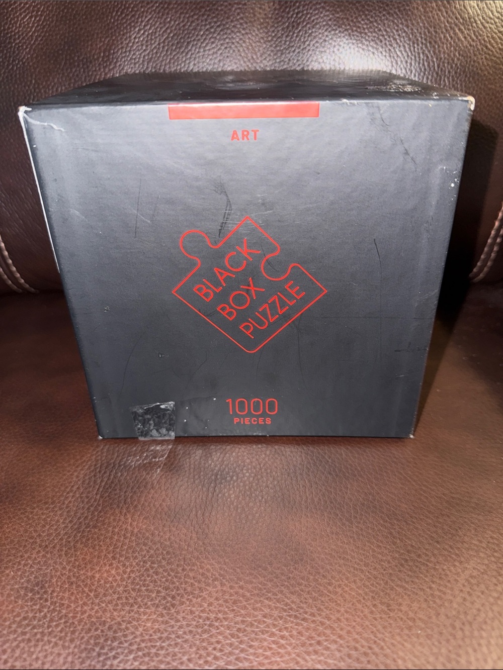 Misu brand Black Box Puzzle 1000-Piece Art Puzzle - Black with Red Accents.